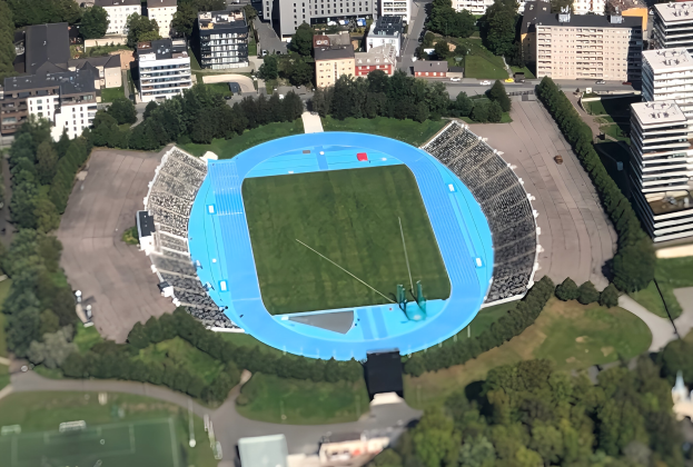 Luftaufnahme des Olympiastadions in München, Deutschland, umgeben von urbaner Infrastruktur und Grünflächen.