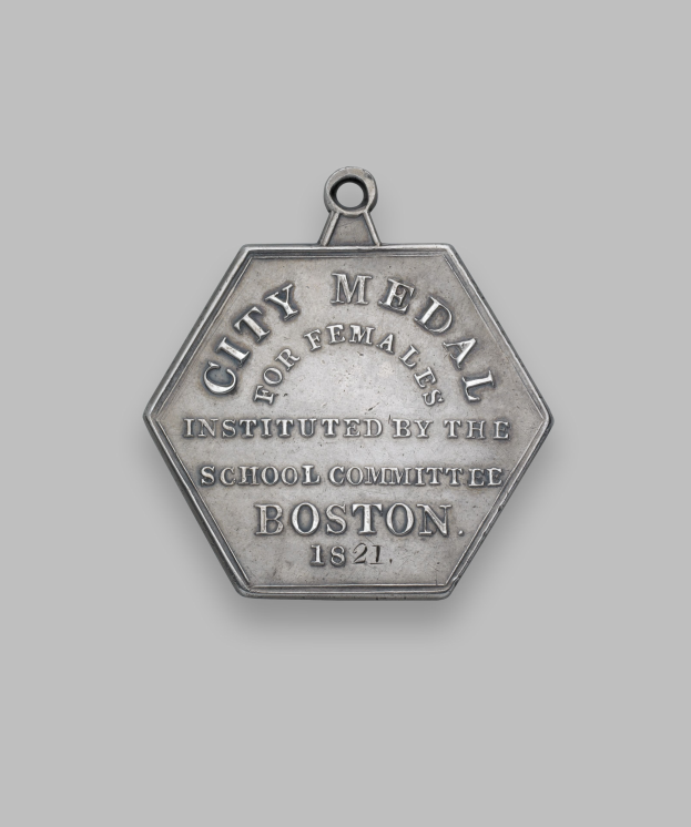 Eine Silbermedaille mit der Aufschrift 'Stadtmedaille für Frauen' auf einem weißen Hintergrund.