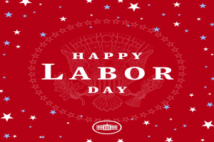 Plakat mit "Glücklicher Arbeitstag" in fetter weißer Schrift auf einem hellroten Hintergrund, umgeben von farbigen Sternen verschiedener Größen.